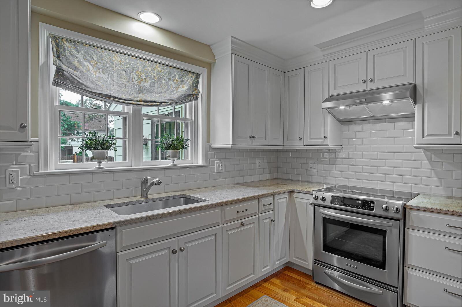 106 Edgewood Road Wilmington, DE 19803 - Photo 15 of 25 a kitchen with a sink stove and cabinets
