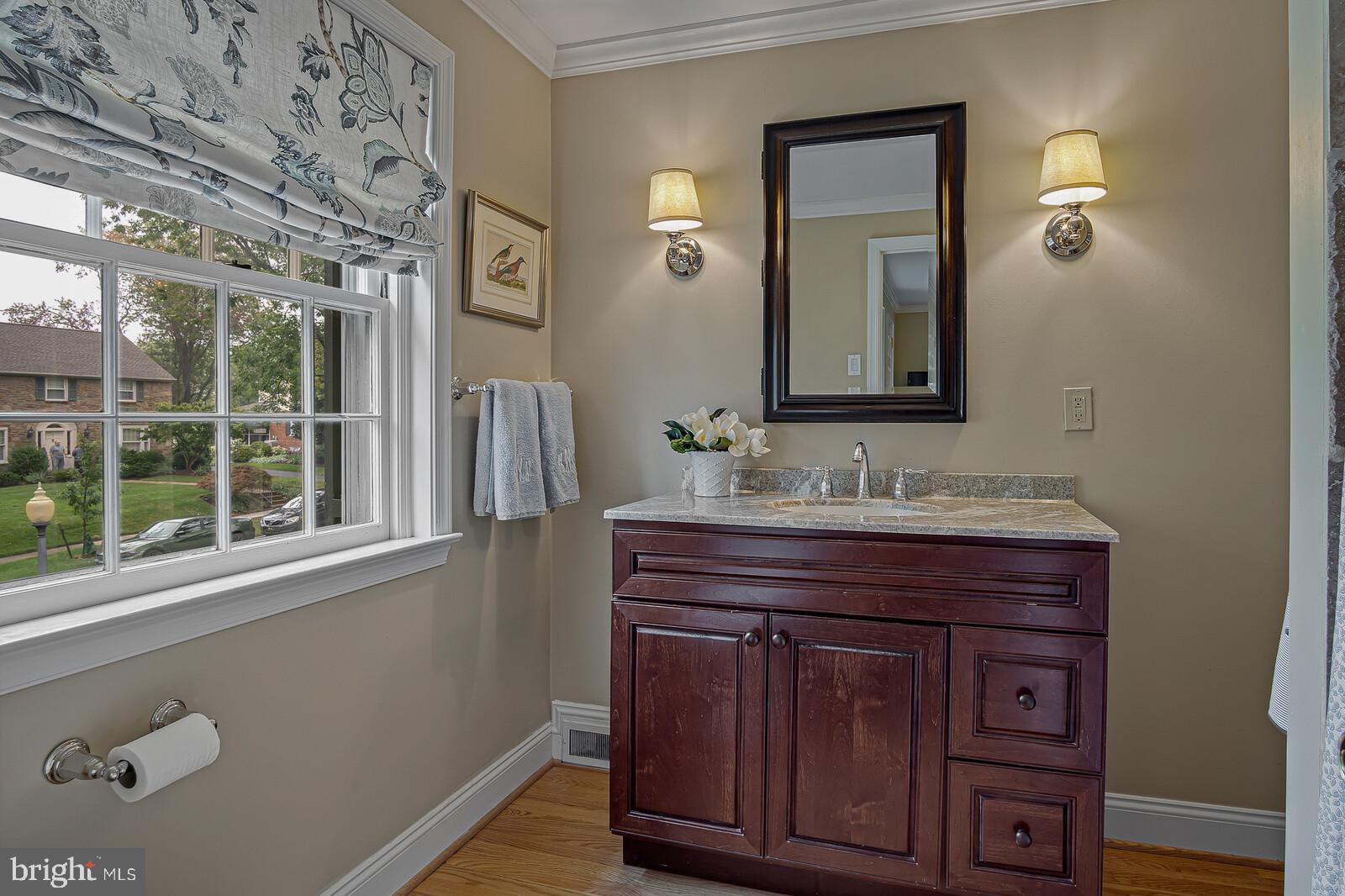 106 Edgewood Road Wilmington, DE 19803 - Photo 17 of 25 a bathroom with a sink a mirror and wooden floors