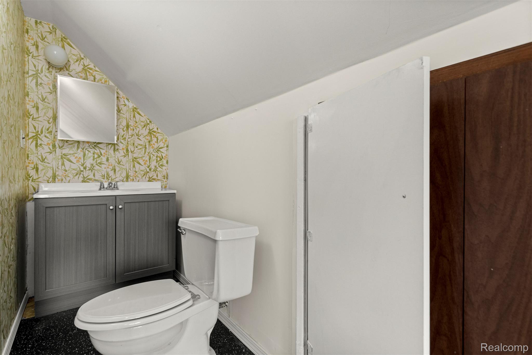 15705 Champaign Road Allen Park, MI 48101 - Photo 25 of 42 Bathroom with vanity, vaulted ceiling, and wallpapered walls
