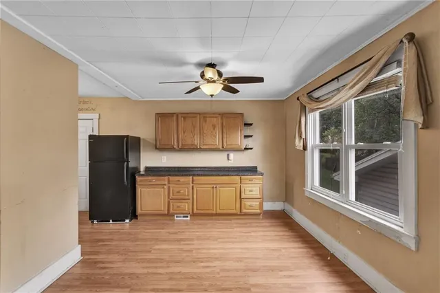 a view of a kitchen with a sink and a refrigerator