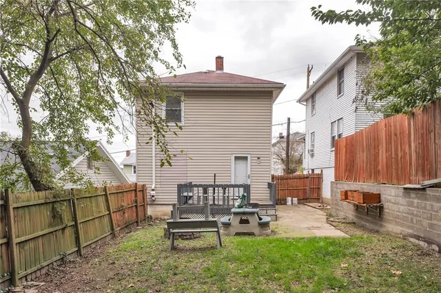 a view of a chairs and table in the backyard