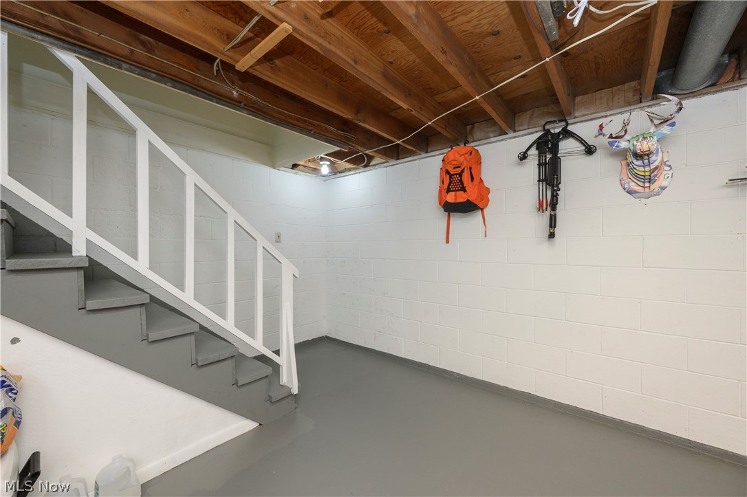 6105 Wolf Run Road Southeast Dennison, OH 44621 - Photo 32 of 35 Lower level featuring concrete block walls and a painted concrete floor