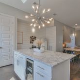 a kitchen with center island table and chairs