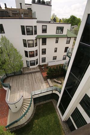 a view of balcony with wooden floor and seating space