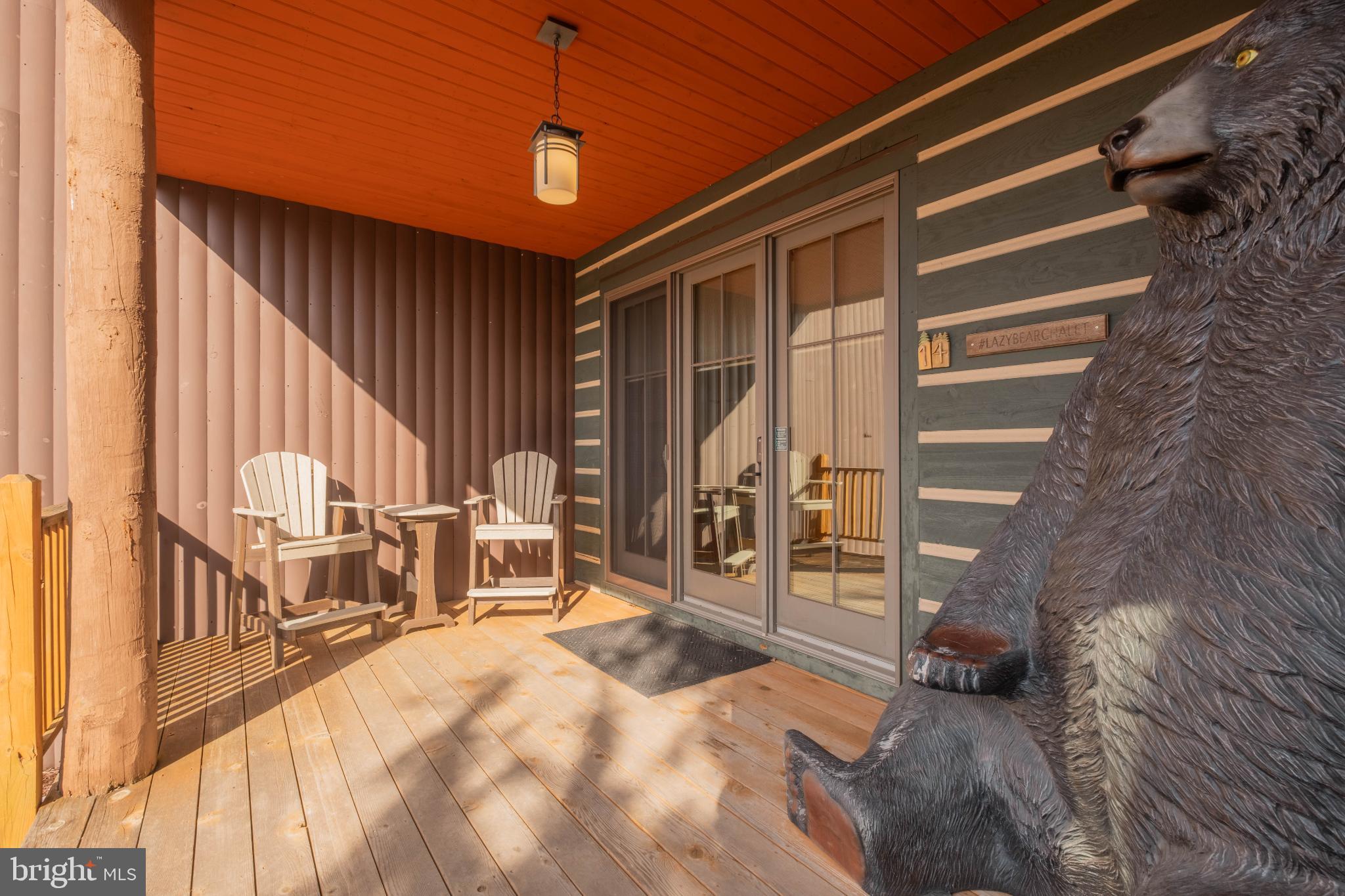 14 Ridge Run Road McHenry, MD 21541 - Photo 54 of 65 Charming porch with rustic bear sculpture.