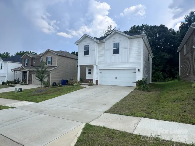 a front view of house with yard and green space