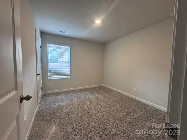 a view of an empty room and a window