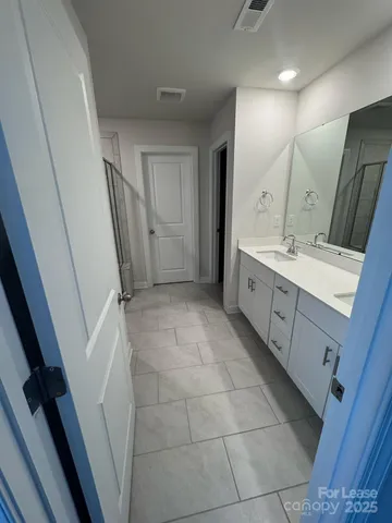 a bathroom with a double vanity sink and mirror