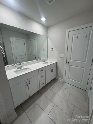 a bathroom with a glass door shower
