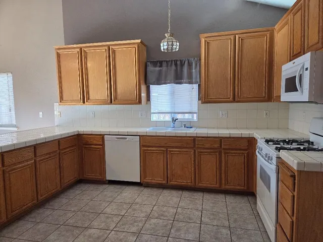 a kitchen with a sink stove and cabinets
