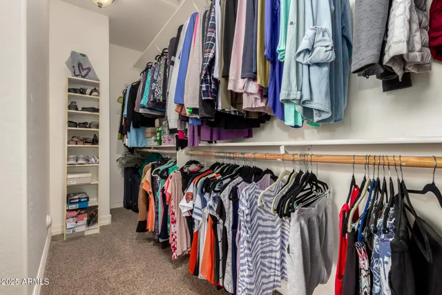 a bedroom with a bed window and wooden floor