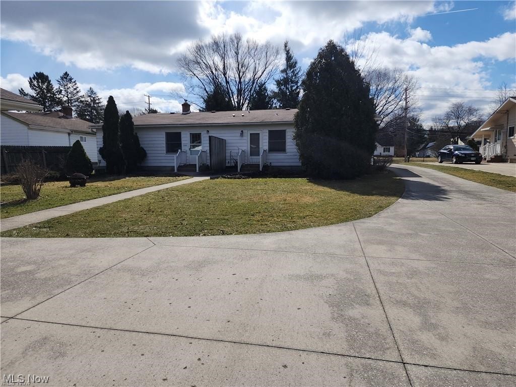 View of back of home featuring a front yard