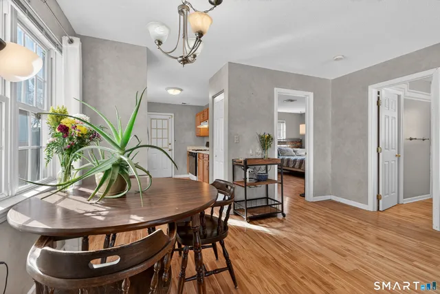 a view of a dining room with furniture and wooden floor