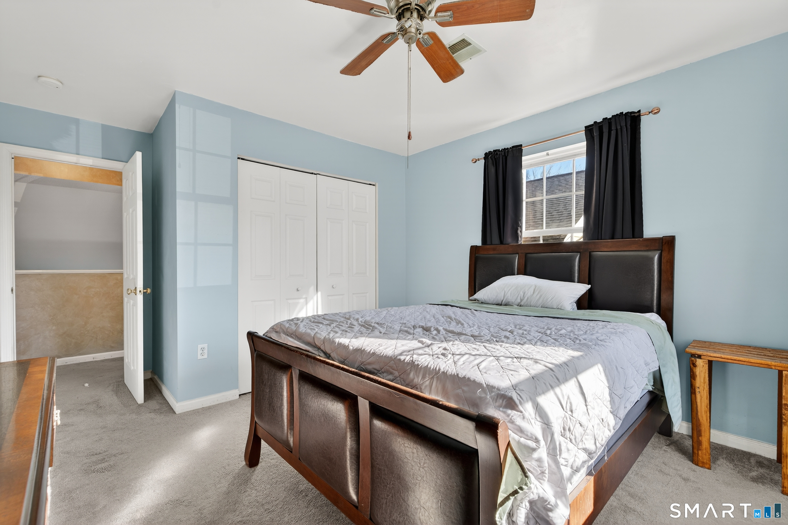 2390 State Street, Unit L17C Hamden, CT 06517 - Photo 15 of 23 a bedroom with a bed and a chandelier