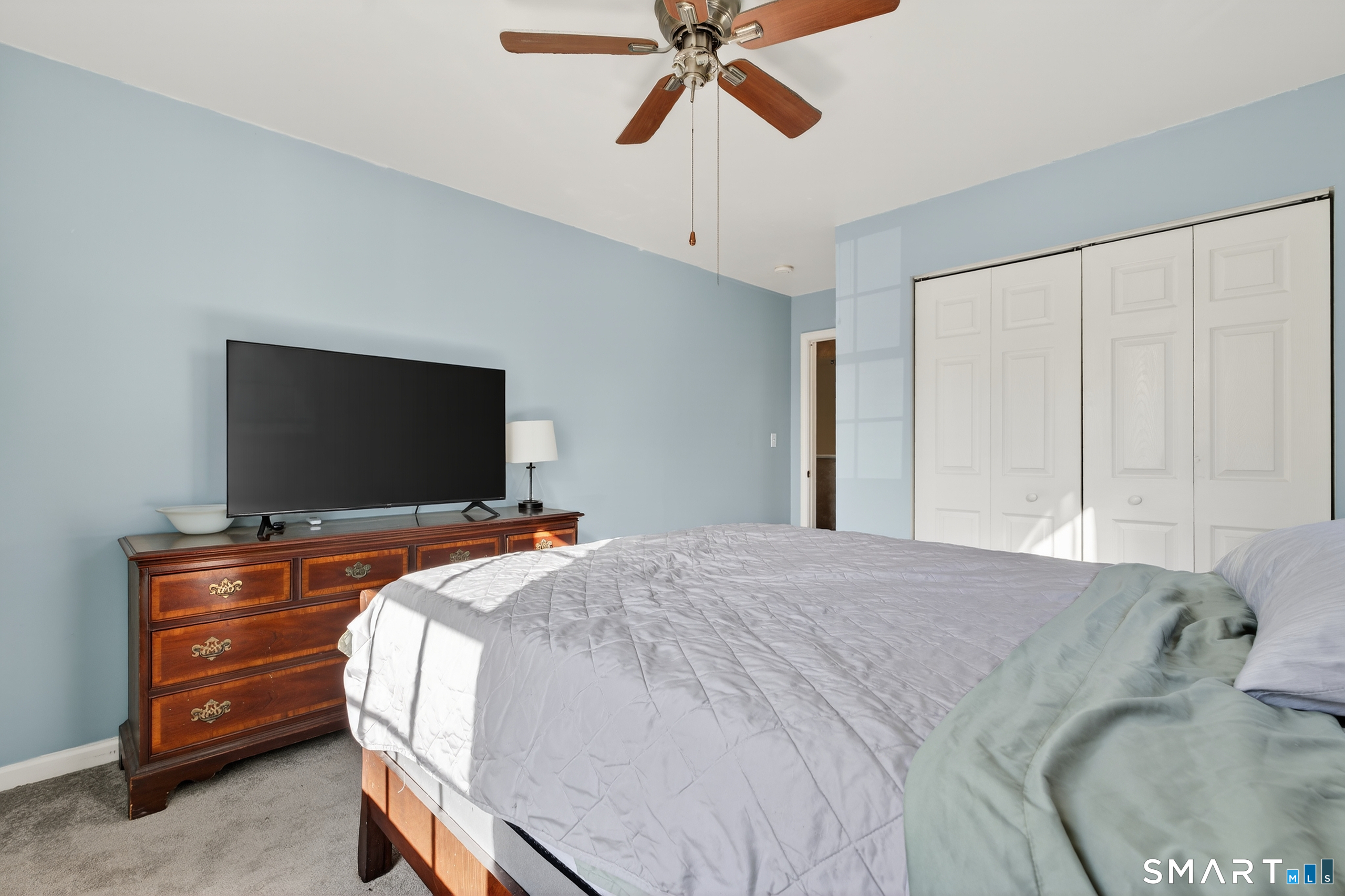 2390 State Street, Unit L17C Hamden, CT 06517 - Photo 16 of 23 a bedroom with a bed and a flat screen tv