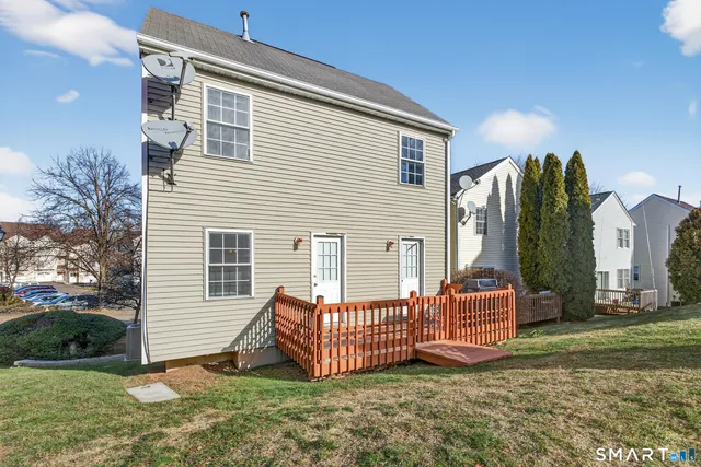 a view of a house with a yard and wooden fence