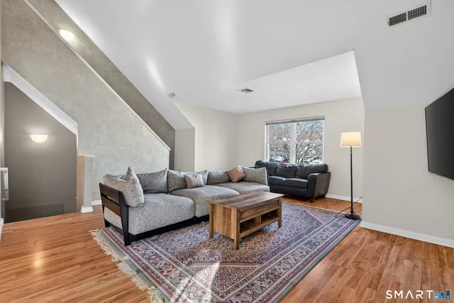 a living room with furniture and a rug