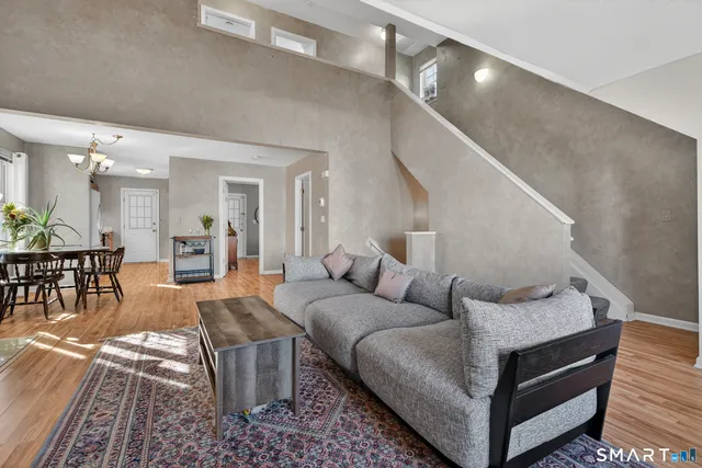 a living room with furniture and wooden floor