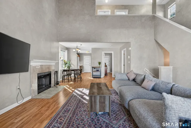 a living room with furniture a fireplace and a flat screen tv