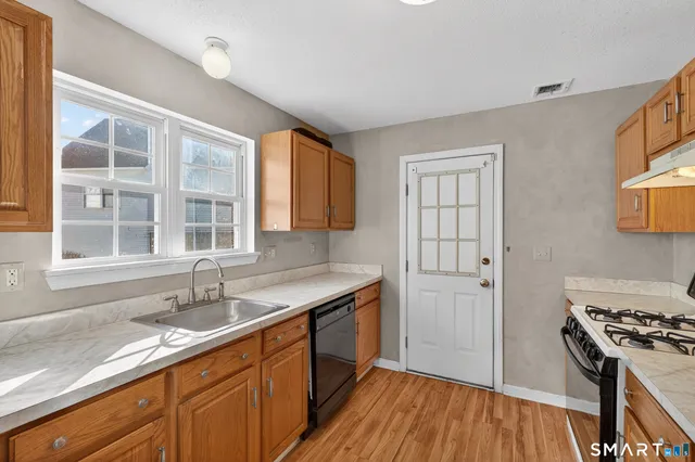 a kitchen with a sink stove and cabinets