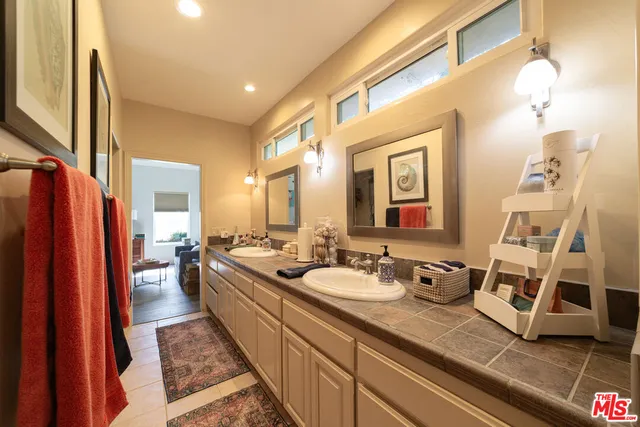 a spacious bathroom with a double vanity sink and a mirror