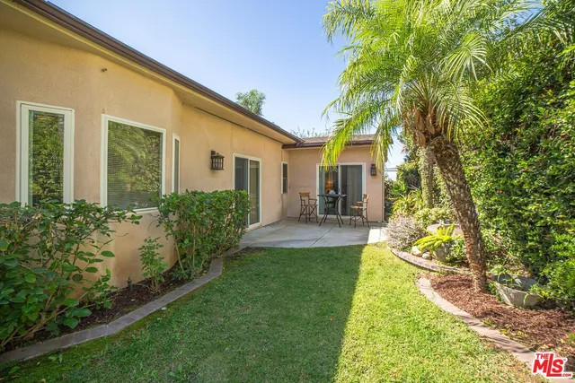 a view of a patio with table and chairs and potted plants