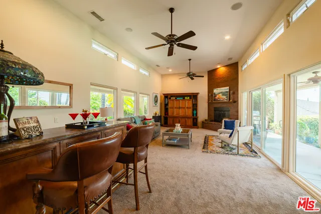 a dining room with furniture a chandelier and wooden floor
