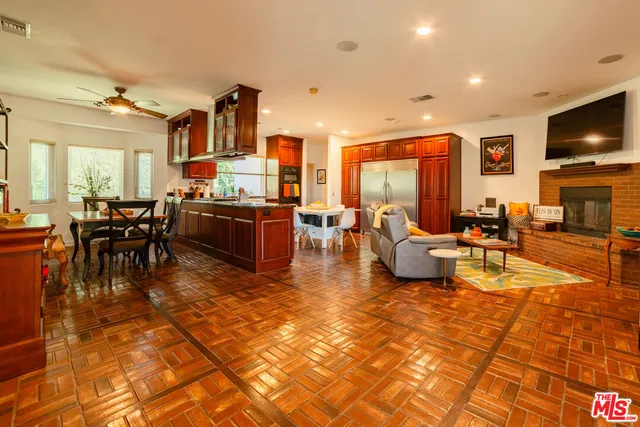 a living room with lots of furniture and kitchen view