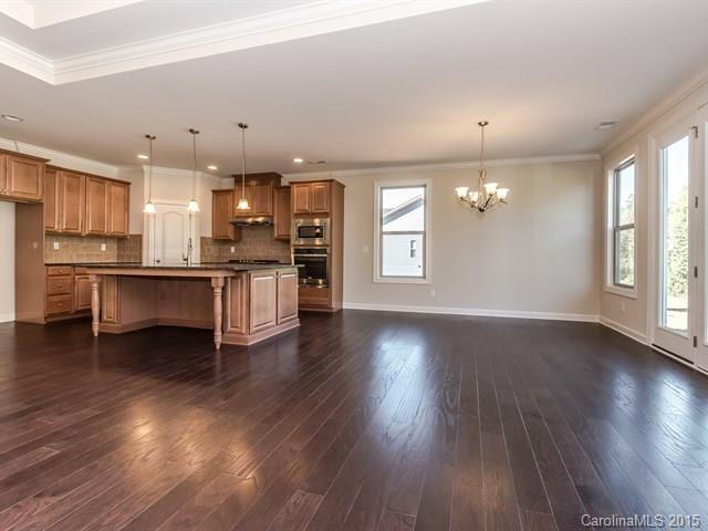 1434 Cilantro Court, Unit 285 Tega Cay, SC 29708 - Photo 11 of 24 a view of a kitchen with a dishwasher cabinets and wooden floor