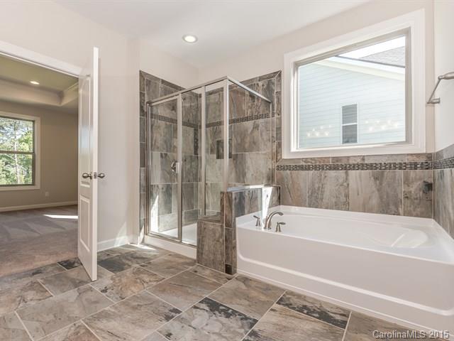 1434 Cilantro Court, Unit 285 Tega Cay, SC 29708 - Photo 17 of 24 a bathroom with a bathtub and a shower