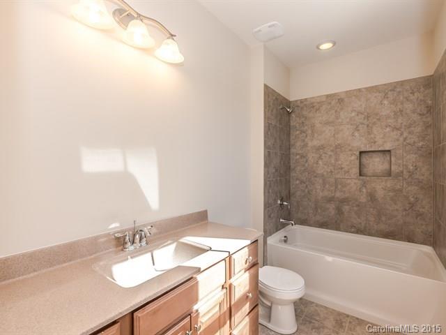 1434 Cilantro Court, Unit 285 Tega Cay, SC 29708 - Photo 19 of 24 a bathroom with a sink a toilet and a bathtub