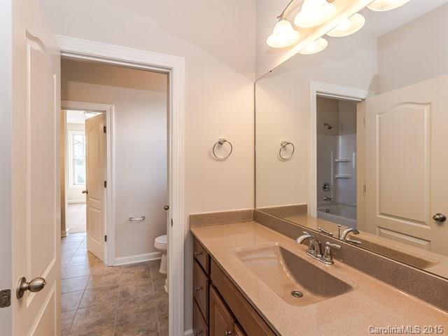 1434 Cilantro Court, Unit 285 Tega Cay, SC 29708 - Photo 20 of 24 a bathroom with a sink vanity granite tub and a mirror
