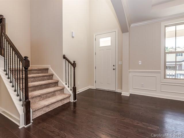 1434 Cilantro Court, Unit 285 Tega Cay, SC 29708 - Photo 3 of 24 an empty room with wooden floor and windows