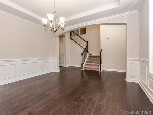 1434 Cilantro Court, Unit 285 Tega Cay, SC 29708 - Photo 5 of 24 a view of a livingroom with wooden floor and a ceiling fan