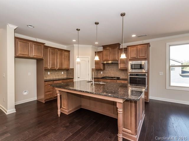 1434 Cilantro Court, Unit 285 Tega Cay, SC 29708 - Photo 6 of 24 a kitchen with stainless steel appliances granite countertop a sink a stove and refrigerator