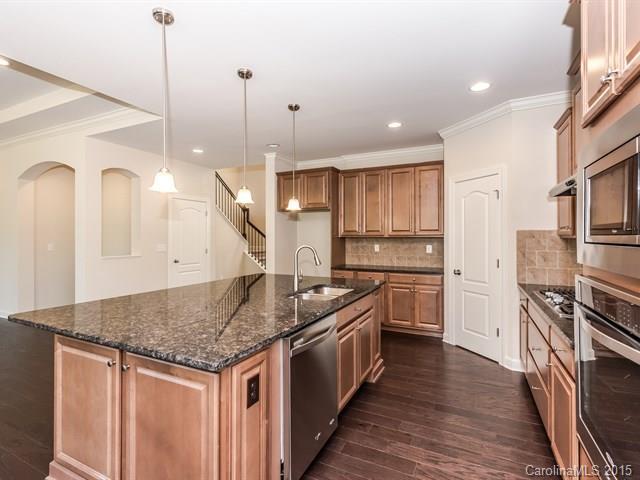 1434 Cilantro Court, Unit 285 Tega Cay, SC 29708 - Photo 7 of 24 a kitchen with stainless steel appliances granite countertop a sink stove and refrigerator