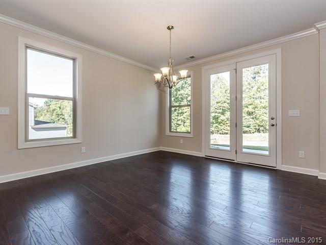 1434 Cilantro Court, Unit 285 Tega Cay, SC 29708 - Photo 8 of 24 an empty room with wooden floor and windows