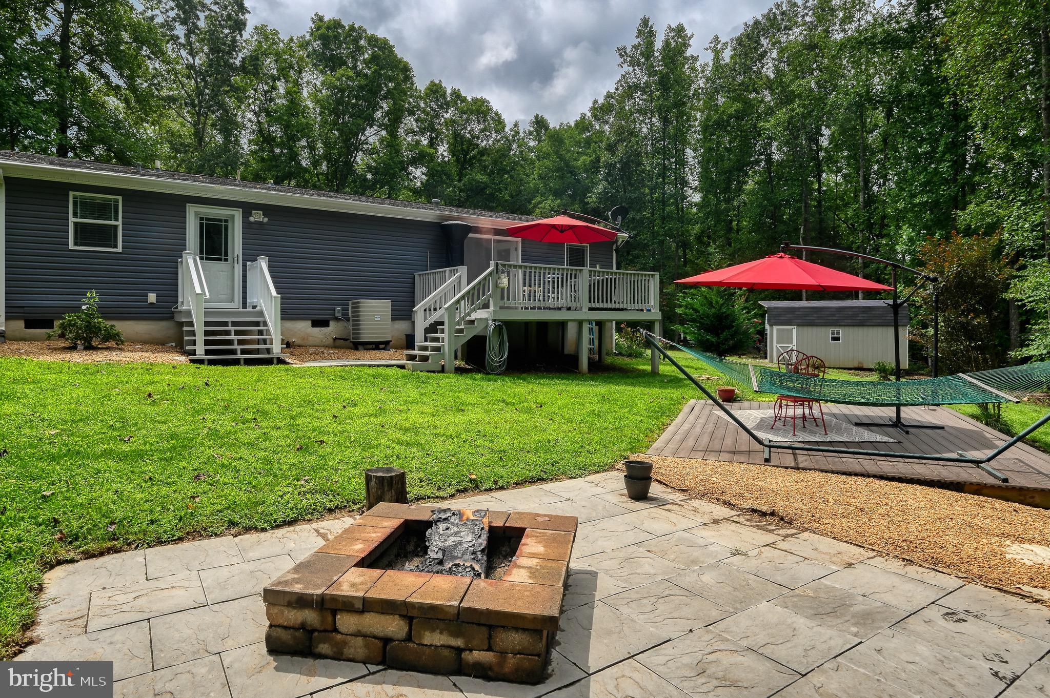 104 Privacy Road Bumpass, VA 23024 - Photo 42 of 81 Hardscaped fire pit area