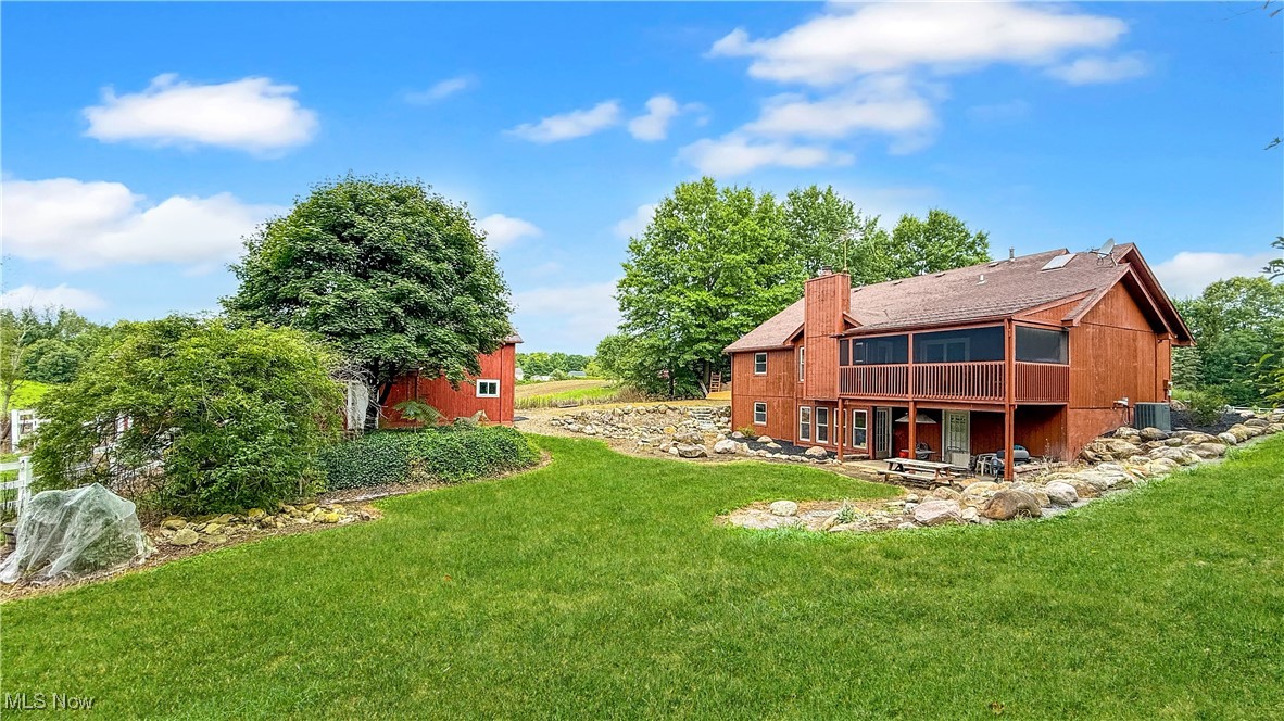 2784 Frost Road Mantua, OH 44255 - Photo 3 of 36 View of green lawn featuring a patio and a wooden deck