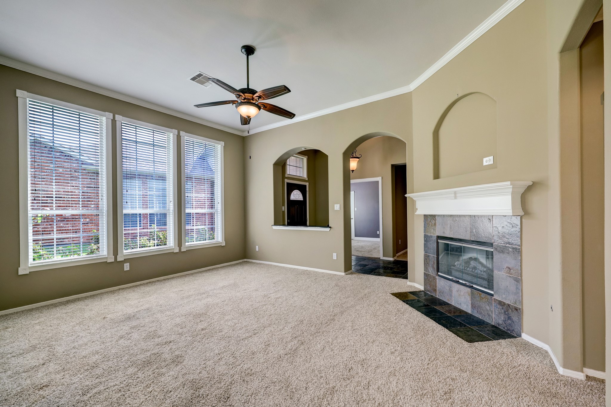 18618 Jaya Loch Court Spring, TX 77379 - Photo 6 of 18 a view of livingroom with fireplace fan and windows
