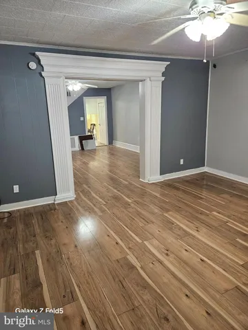 a view of a room with wooden floor and staircase