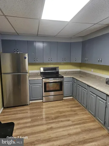 a kitchen with wooden cabinets and a stove top oven