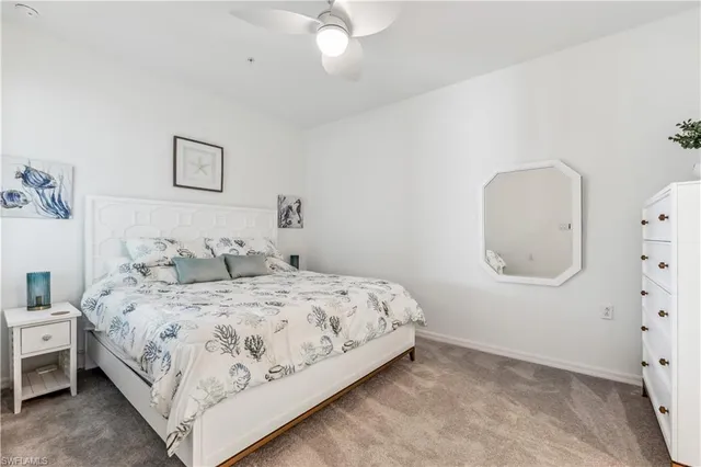 a bedroom with a bed a mirror and lamp