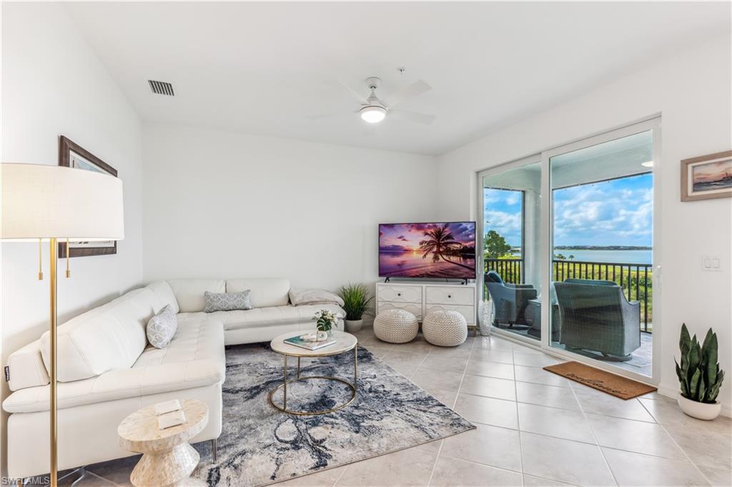43060 Greenway Boulevard, Unit 742 Babcock Ranch, FL 33982 - Photo 3 of 12 a living room with furniture a rug and a potted plant