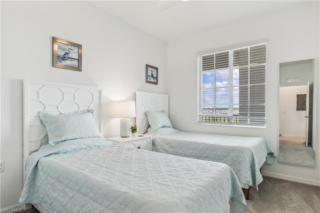 43060 Greenway Boulevard, Unit 742 Babcock Ranch, FL 33982 - Photo 8 of 12 a bedroom with a large bed and a window