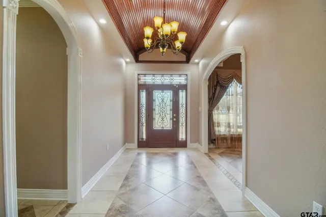 a view of a hall with a dining table and chairs