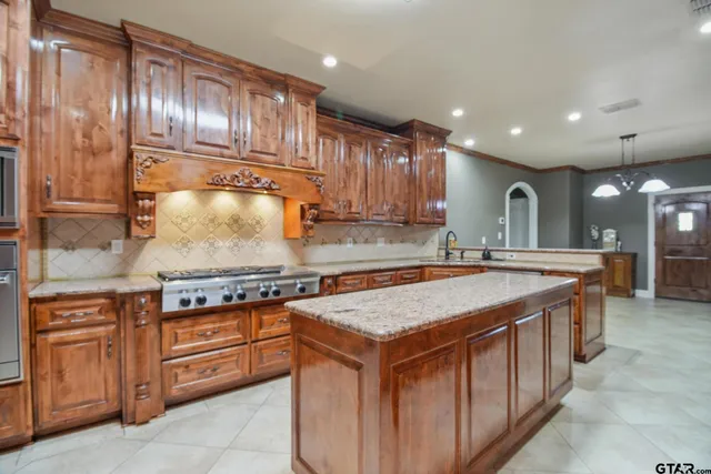 a spacious bathroom with a granite countertop tub sink and mirror