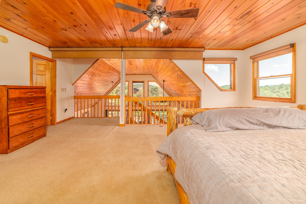 730 Dillon Oaks Drive Murphy, NC 28906 - Photo 21 of 38 a bedroom with a bed and a large window with the outer view