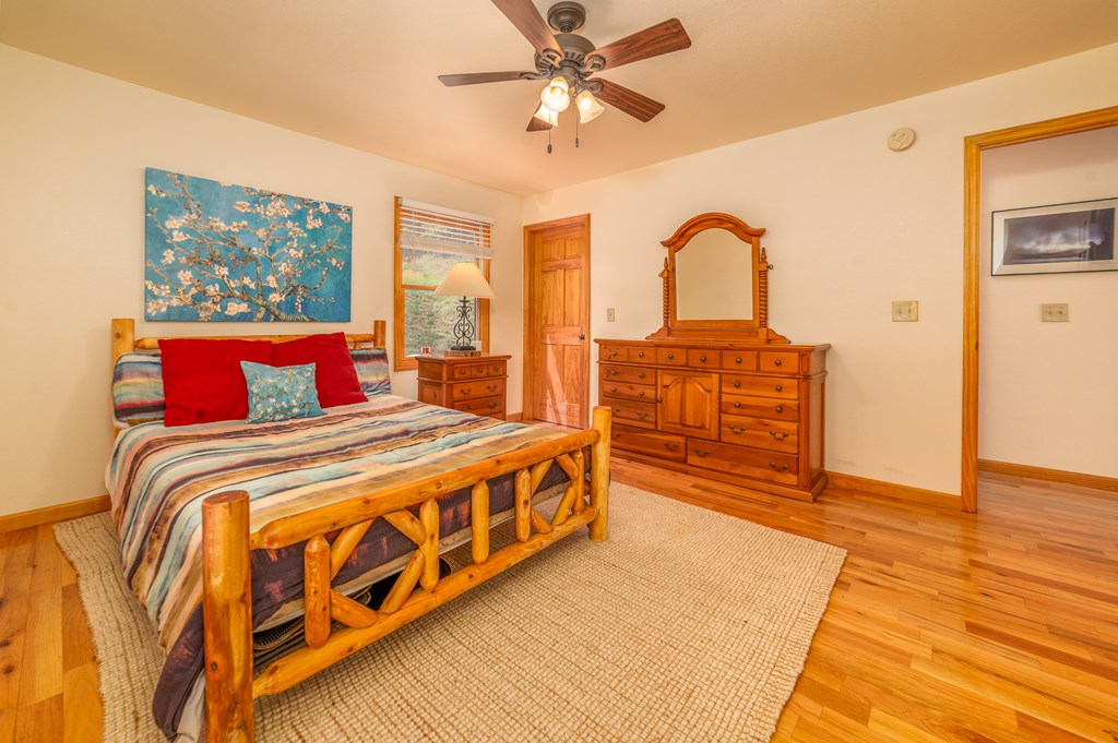 730 Dillon Oaks Drive Murphy, NC 28906 - Photo 26 of 38 a bedroom with a bed and a dresser with wooden floor