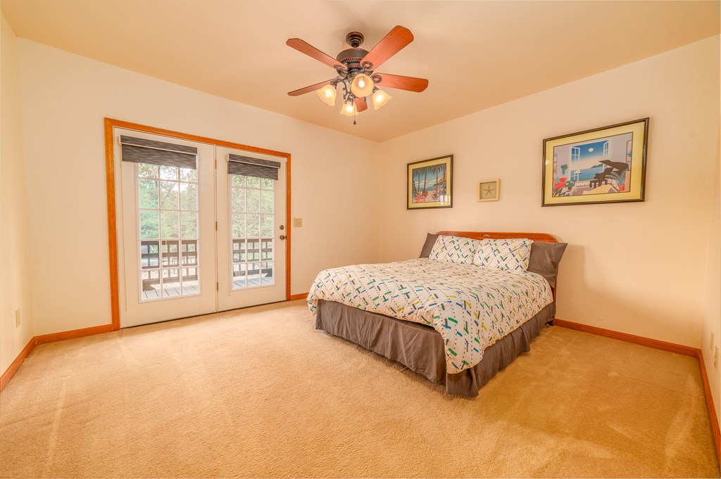 730 Dillon Oaks Drive Murphy, NC 28906 - Photo 31 of 38 a spacious bedroom with a large bed and a chandelier